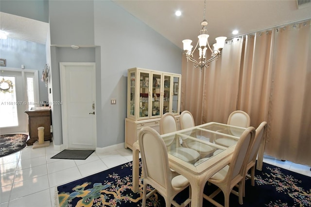 dining space with light tile patterned flooring, high vaulted ceiling, and an inviting chandelier