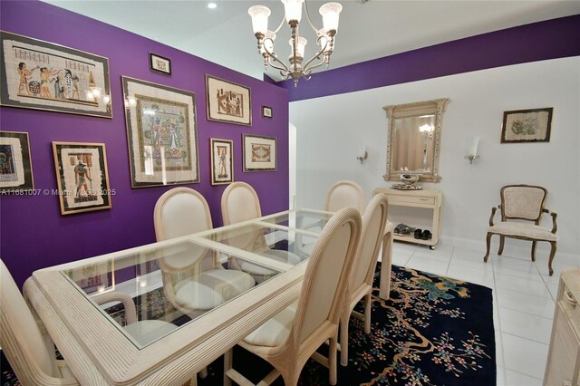 dining area featuring tile patterned flooring, a notable chandelier, and baseboards
