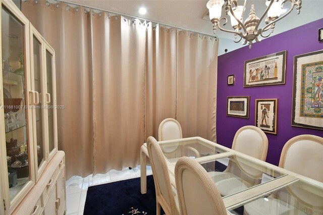 dining space with a notable chandelier and tile patterned floors