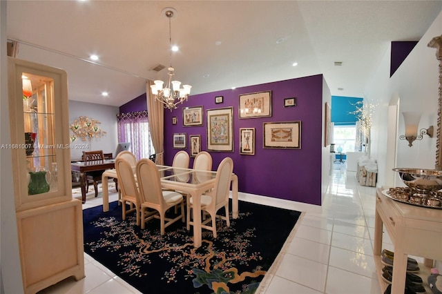 tiled dining space featuring an inviting chandelier and lofted ceiling