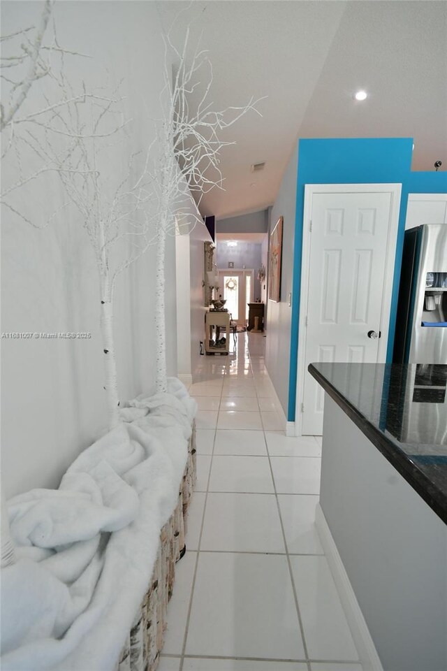 corridor with light tile patterned floors, recessed lighting, and baseboards