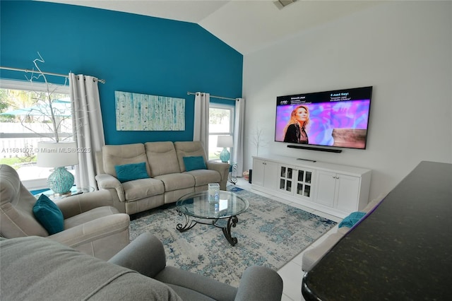 living room featuring lofted ceiling