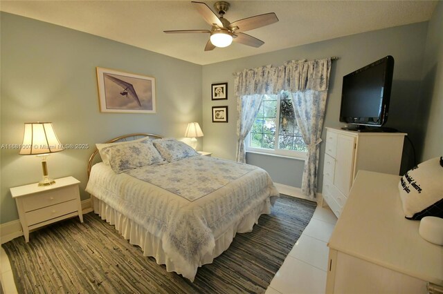 bedroom featuring dark tile patterned flooring and ceiling fan