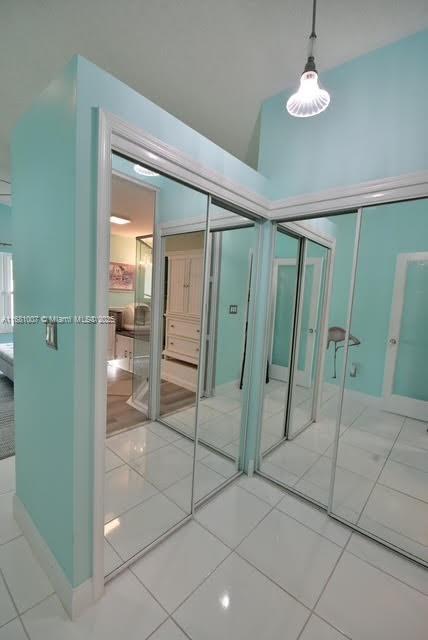 unfurnished bedroom featuring tile patterned floors and a closet