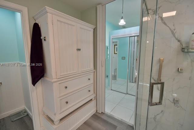 bathroom with a marble finish shower