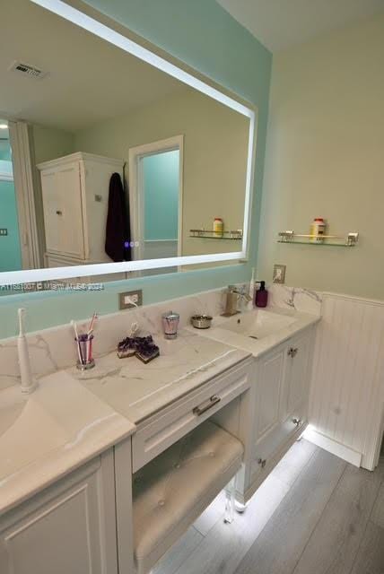 bathroom with vanity and hardwood / wood-style floors