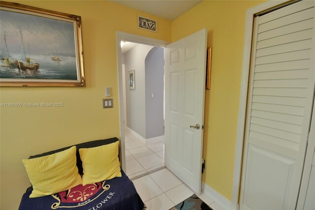 bedroom featuring a closet and light tile patterned floors