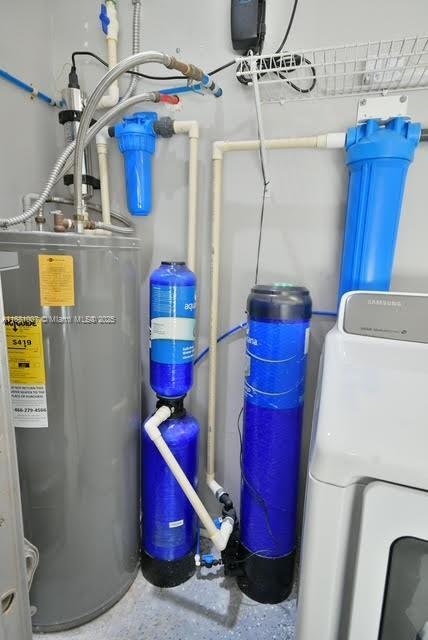utility room featuring washer / dryer and water heater