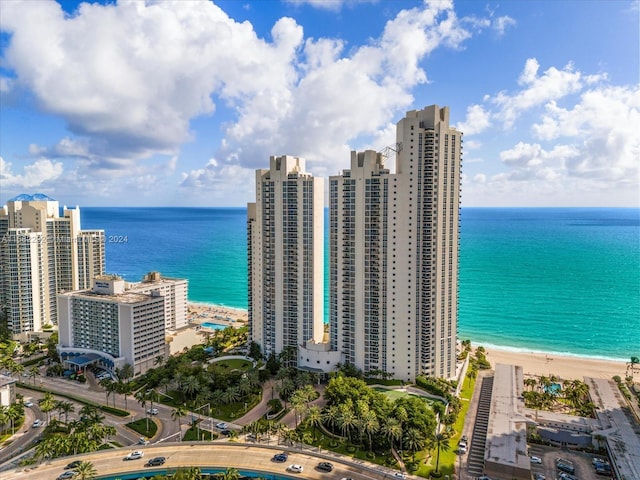 bird's eye view featuring a water view and a beach view