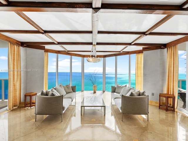 living room with a water view and a wall of windows