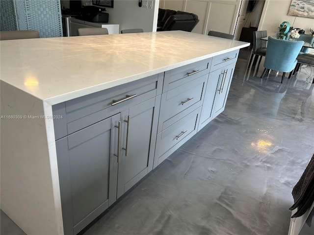 kitchen with a kitchen island and gray cabinetry