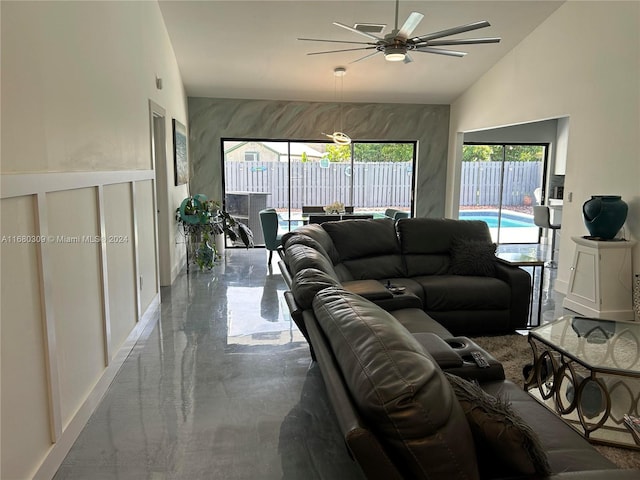 living room with concrete flooring, high vaulted ceiling, and ceiling fan