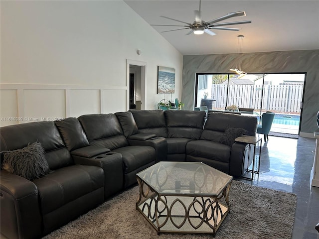 living room with high vaulted ceiling, concrete floors, and ceiling fan