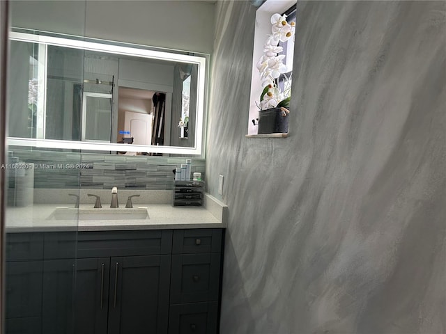 bathroom with vanity and decorative backsplash