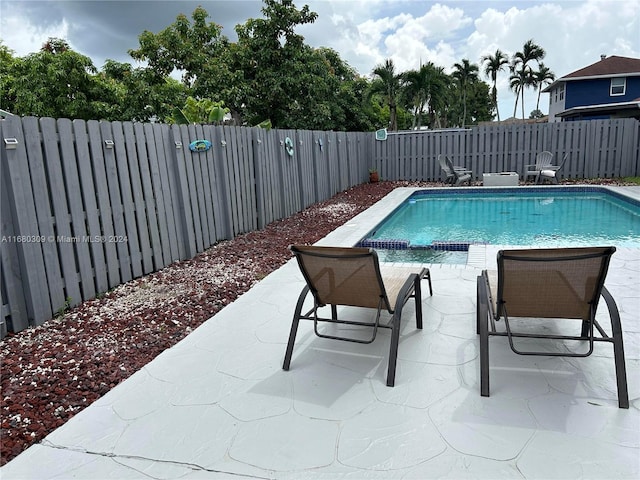 view of swimming pool featuring a patio area