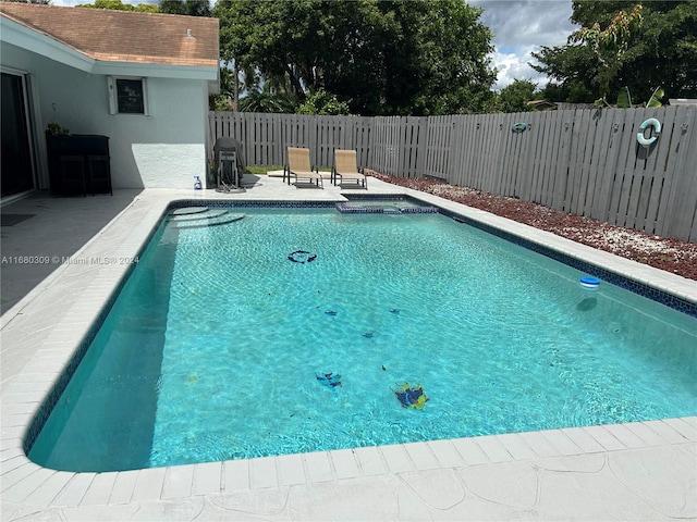 view of swimming pool with a patio area