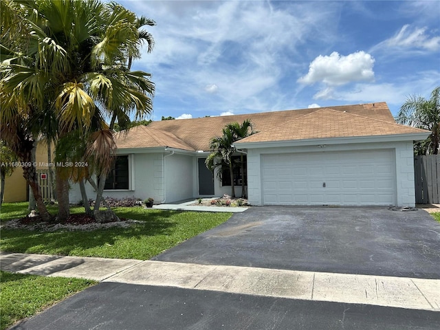 single story home with a front lawn and a garage