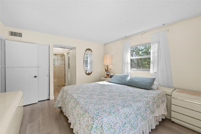 bedroom featuring a closet and light wood-type flooring