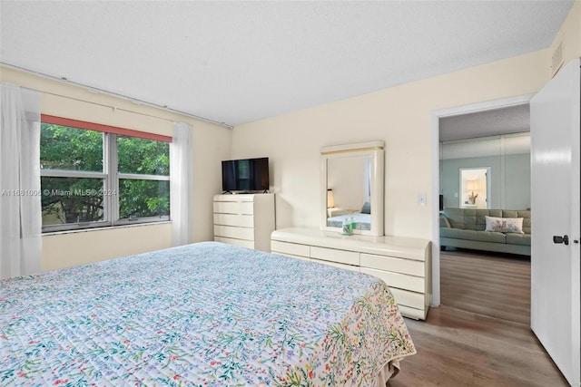 bedroom featuring hardwood / wood-style floors and a textured ceiling