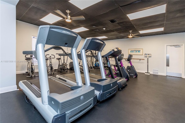 gym featuring a drop ceiling and ceiling fan