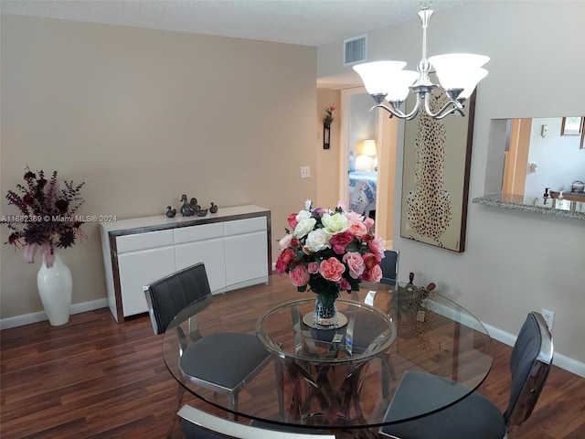 dining area featuring a notable chandelier and dark hardwood / wood-style flooring