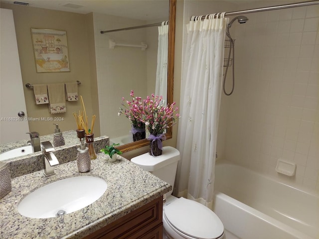 full bathroom featuring toilet, shower / bath combo, and vanity