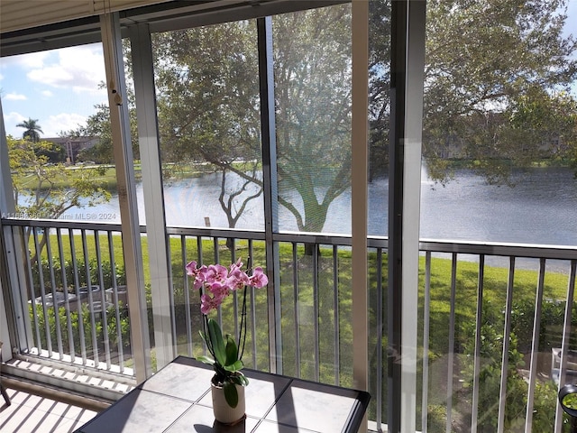 unfurnished sunroom with a water view