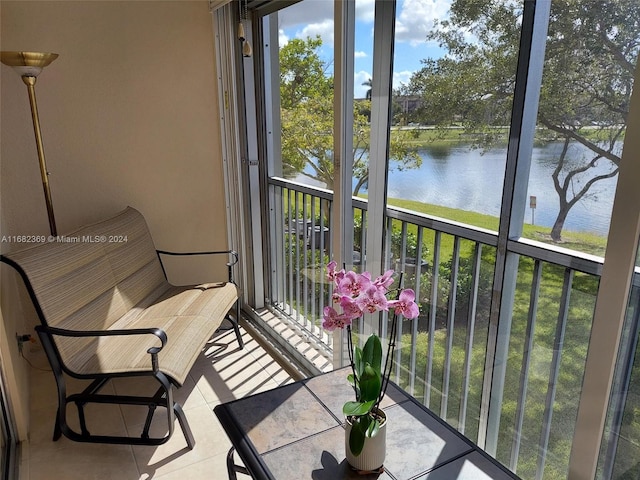 sunroom / solarium with a water view