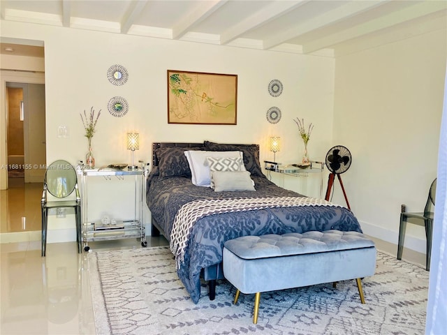 bedroom featuring baseboards and beamed ceiling