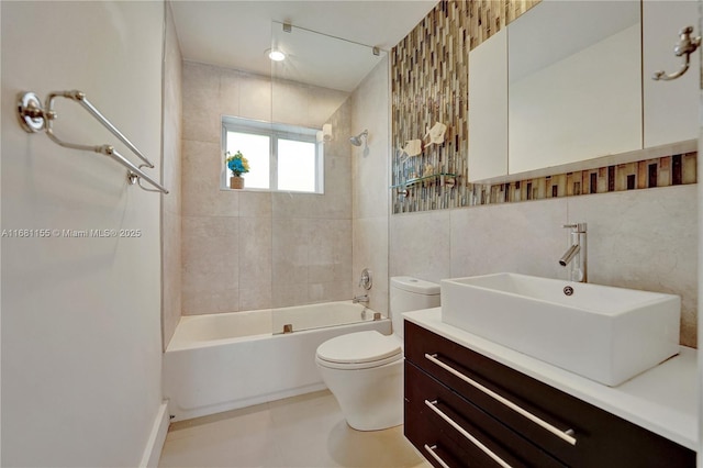 full bath featuring bathtub / shower combination, toilet, vanity, tile walls, and tasteful backsplash