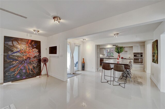 bedroom with wooden ceiling, light tile patterned flooring, and beamed ceiling