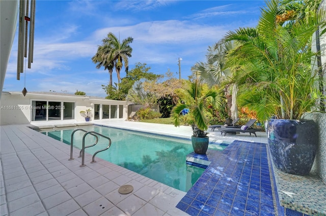 outdoor pool with a patio area