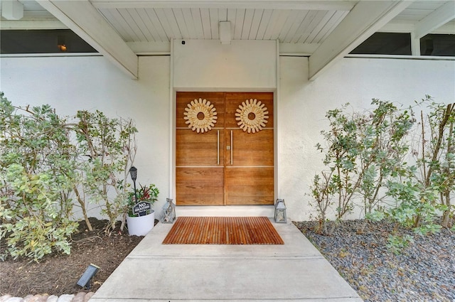 entrance to property featuring stucco siding