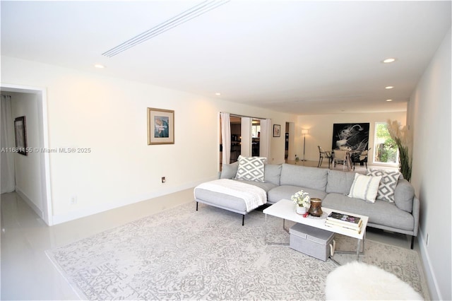 living area featuring recessed lighting and baseboards