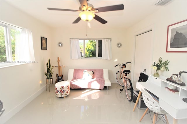 sitting room featuring tile patterned flooring, a healthy amount of sunlight, visible vents, and baseboards