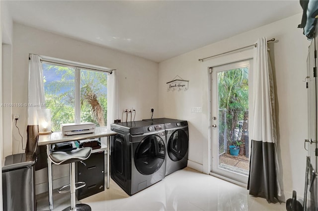 laundry area featuring laundry area, separate washer and dryer, and a healthy amount of sunlight