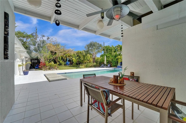 view of patio / terrace with a ceiling fan and an outdoor pool