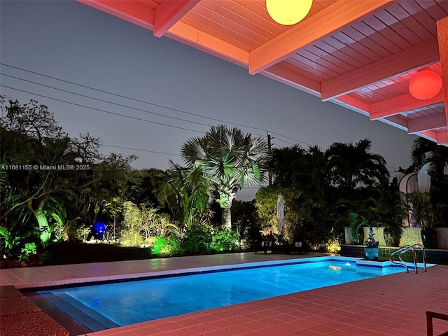 pool at dusk with an outdoor pool