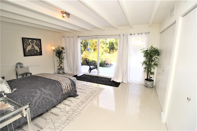 bedroom featuring access to outside, beamed ceiling, and light tile patterned floors