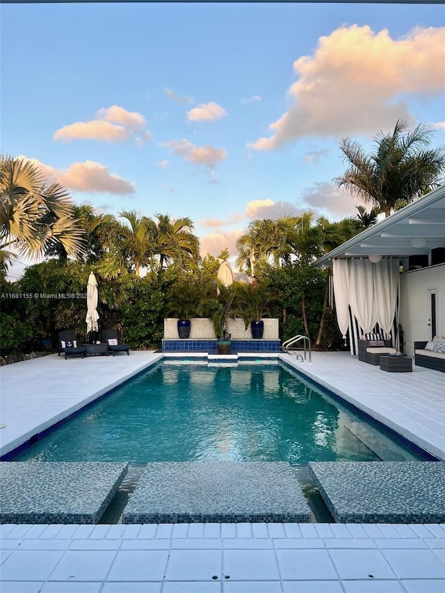 outdoor pool with a patio area