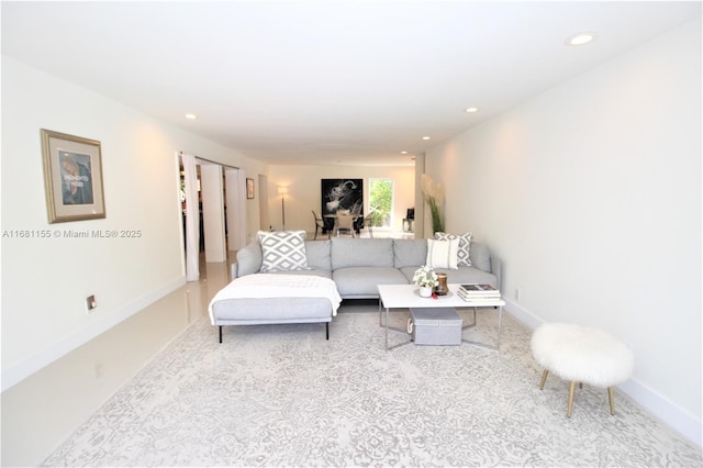 living room with recessed lighting, carpet flooring, and baseboards