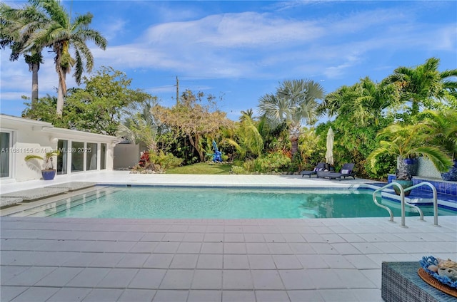 outdoor pool with a patio area