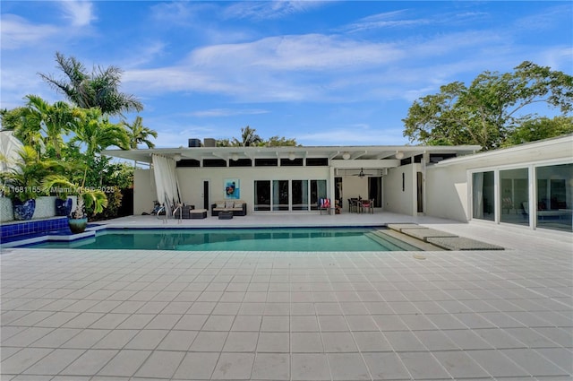 pool with a patio area and ceiling fan