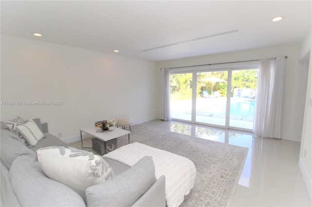 living area with baseboards and recessed lighting