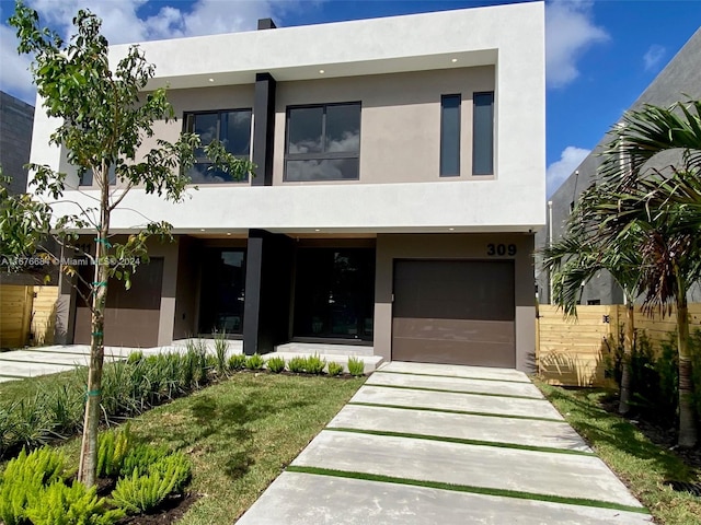 contemporary house with a garage and a front lawn