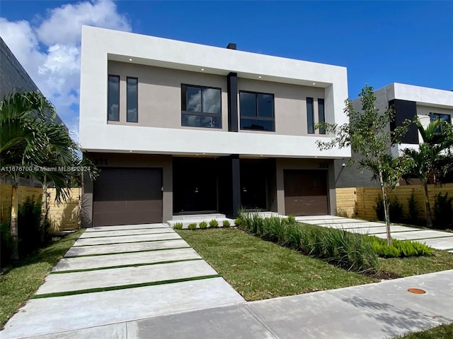 contemporary home with a front yard and a garage