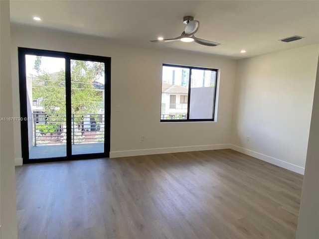 spare room with plenty of natural light and hardwood / wood-style floors