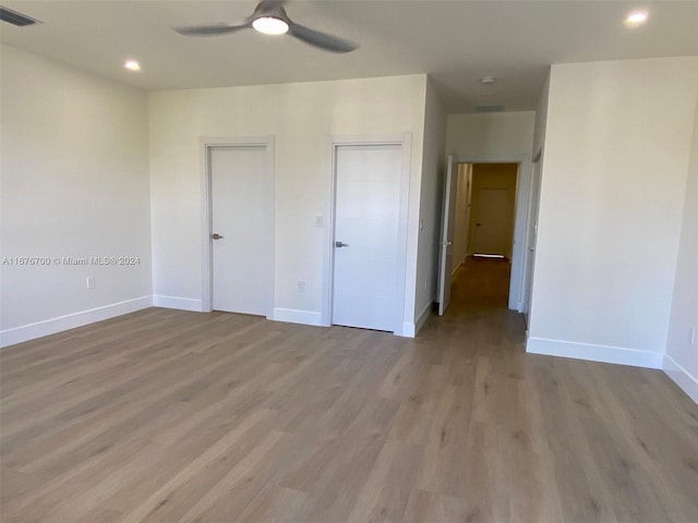 unfurnished bedroom featuring ceiling fan and light wood-type flooring