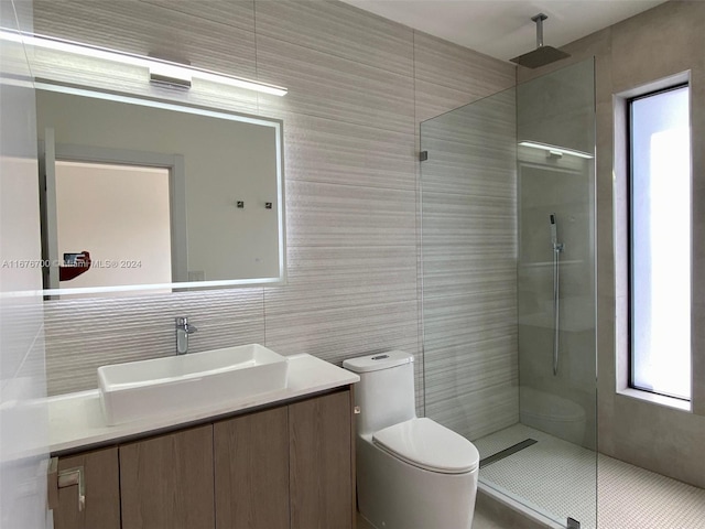 bathroom featuring vanity, tile patterned flooring, toilet, tile walls, and an enclosed shower