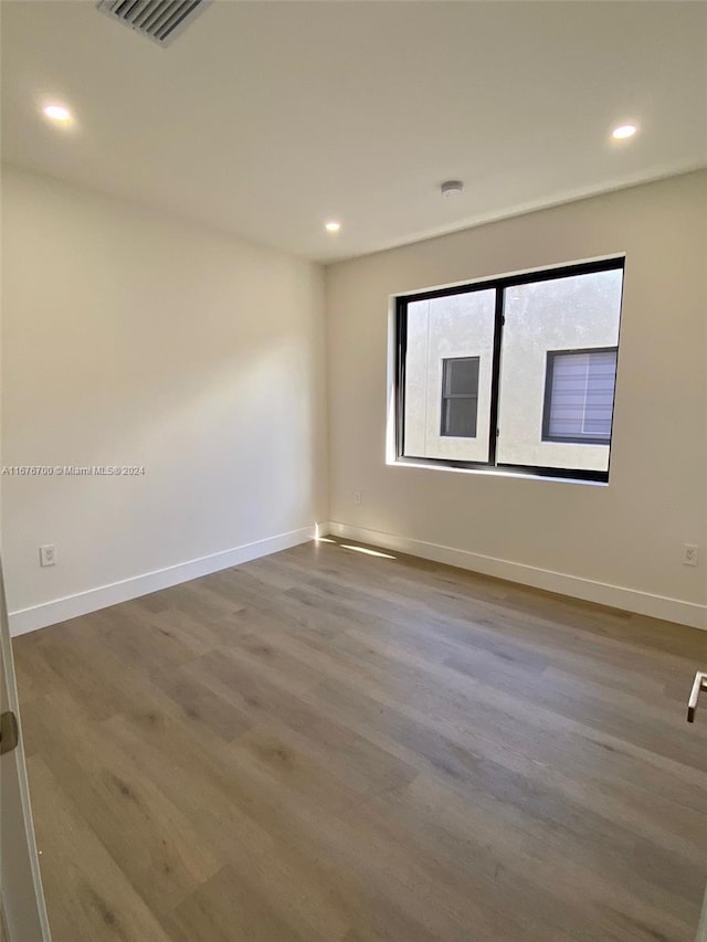 empty room featuring wood-type flooring